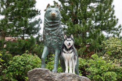 Photo of Jonathan standing with the Jonathan statue on the UConn campus on a beautiful fall day.
